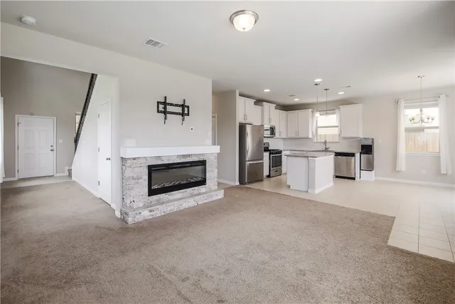 a view of a kitchen with a sink and a fireplace