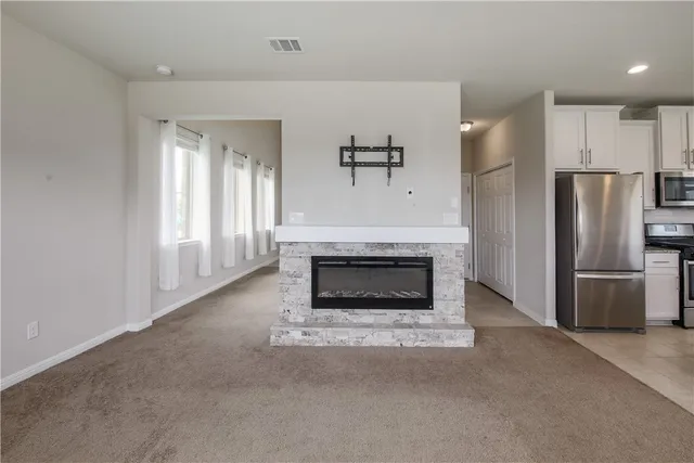 a living room with a fireplace and a fireplace