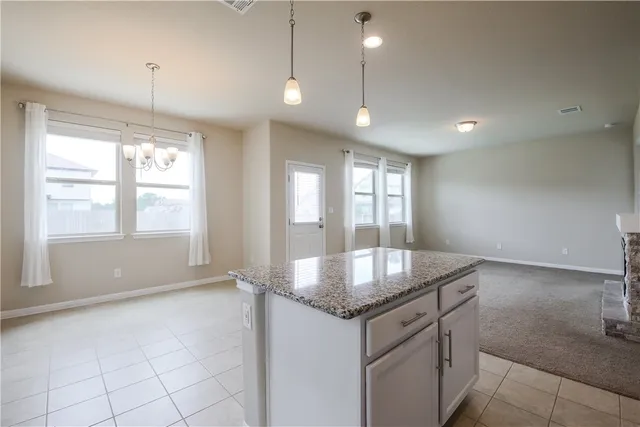 a kitchen with granite countertop a sink and a window