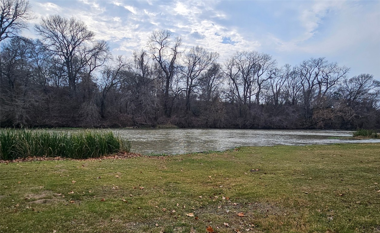 416 Riverside Drive Bastrop, TX 78602 - Photo 3 of 8 a view of pool with trees in the background