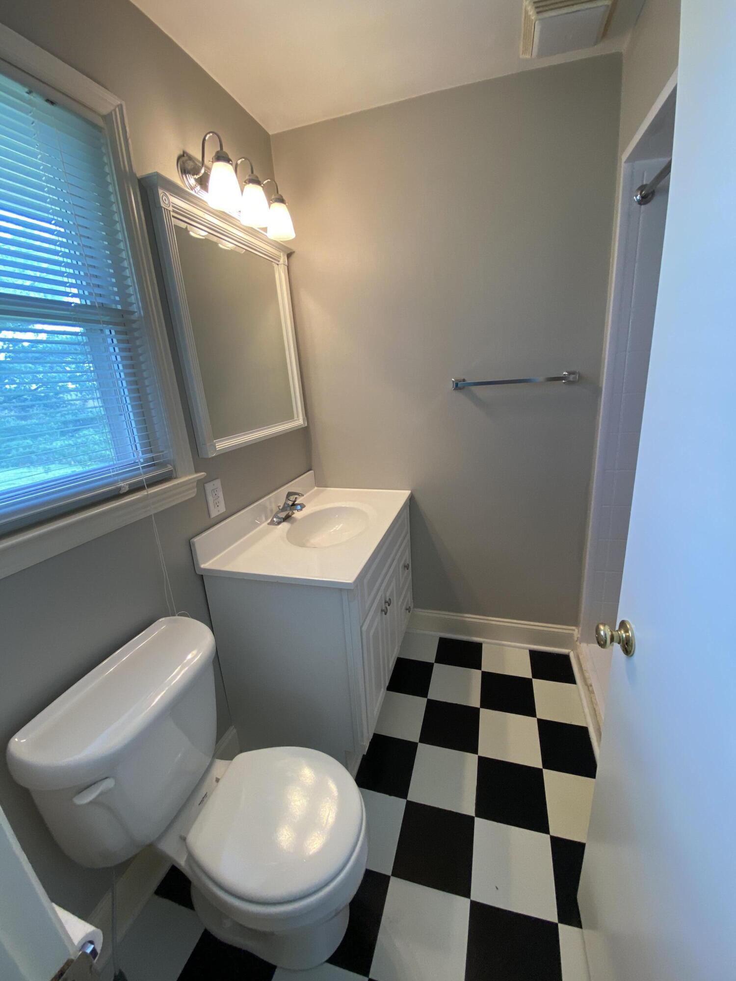 1888 Trails End Road Goodview, VA 24095 - Photo 14 of 18 a bathroom with a toilet a sink and a mirror