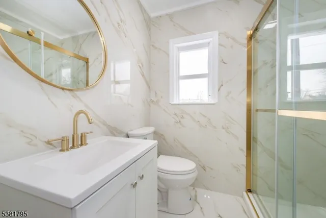 a bathroom with a toilet a sink and a window