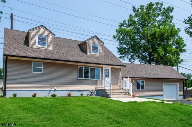 a front view of a house with a garden and yard