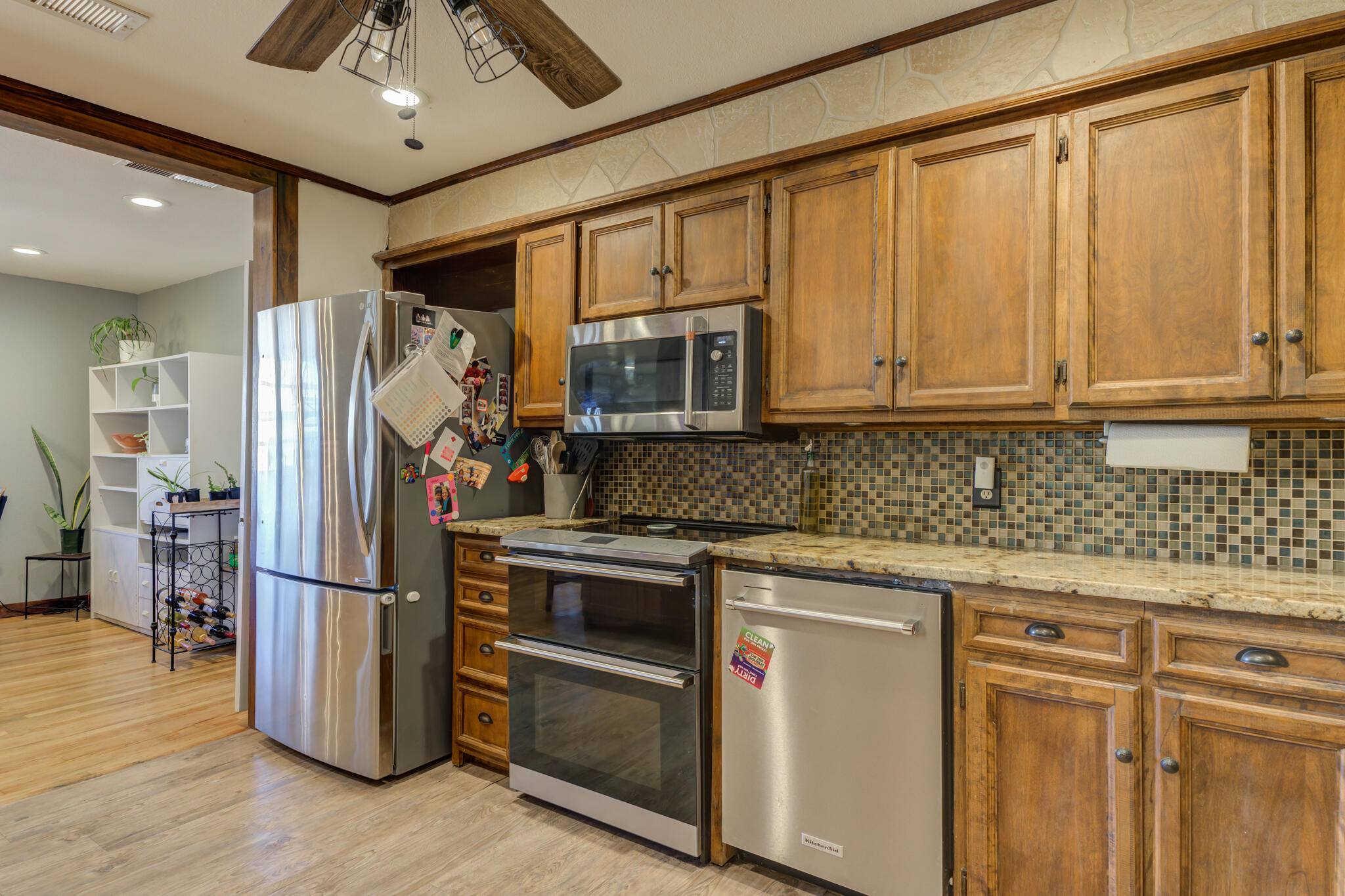 2741 County Road 3 Slaton, TX 79364 - Photo 12 of 51 a kitchen with stainless steel appliances granite countertop a refrigerator and a stove top oven