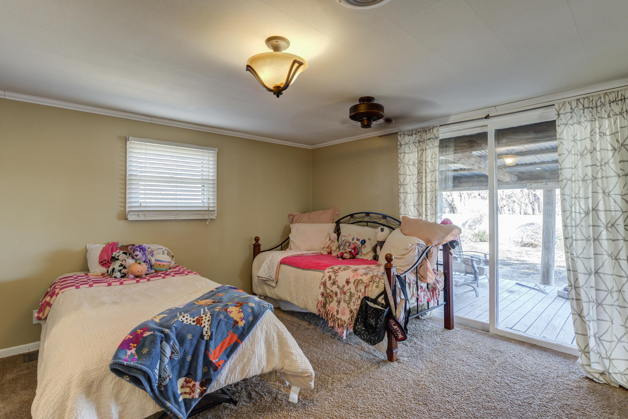 2741 County Road 3 Slaton, TX 79364 - Photo 27 of 51 a bedroom with two beds and a window
