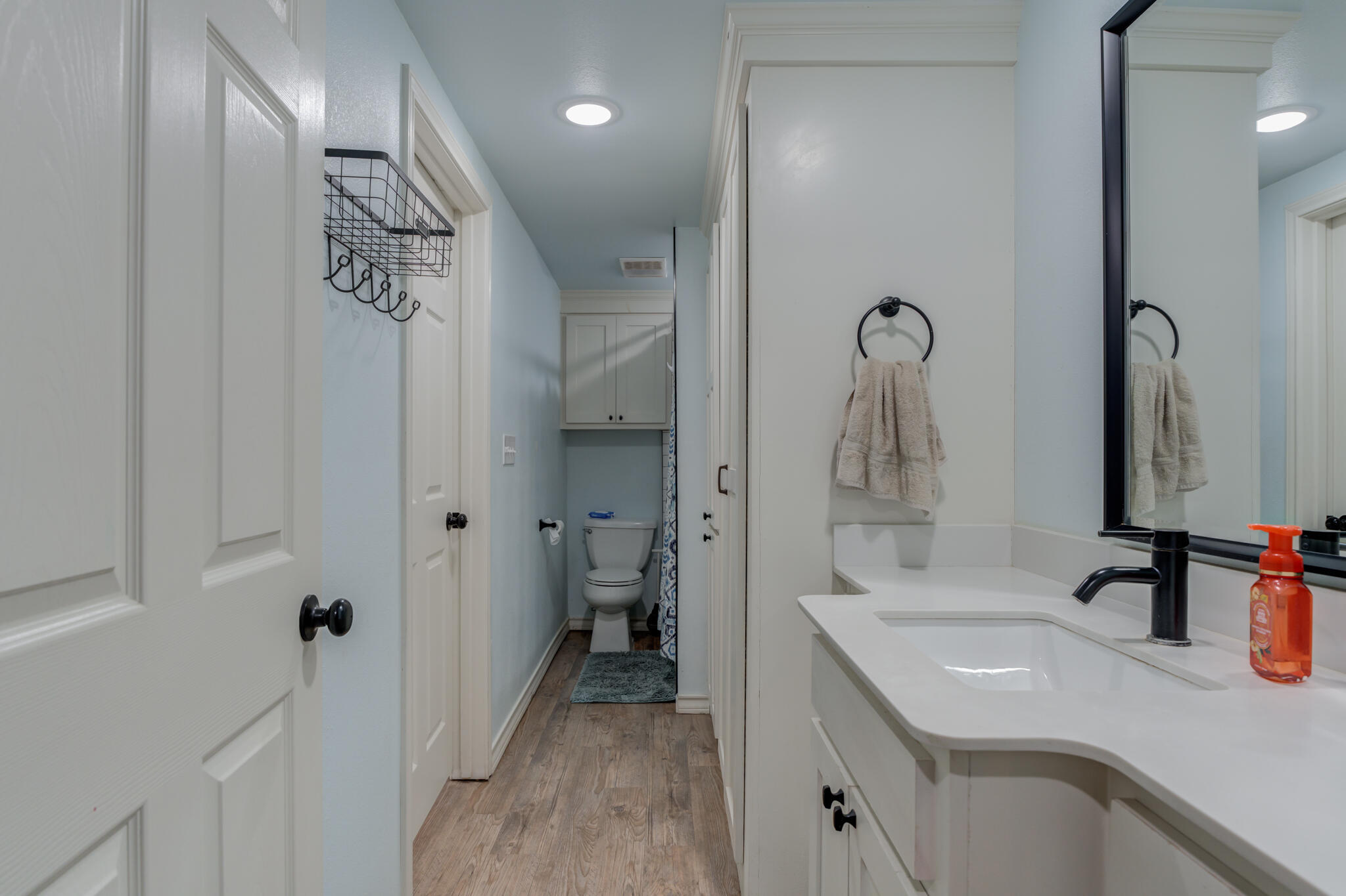 2741 County Road 3 Slaton, TX 79364 - Photo 38 of 51 a bathroom with a granite countertop sink a toilet and a mirror