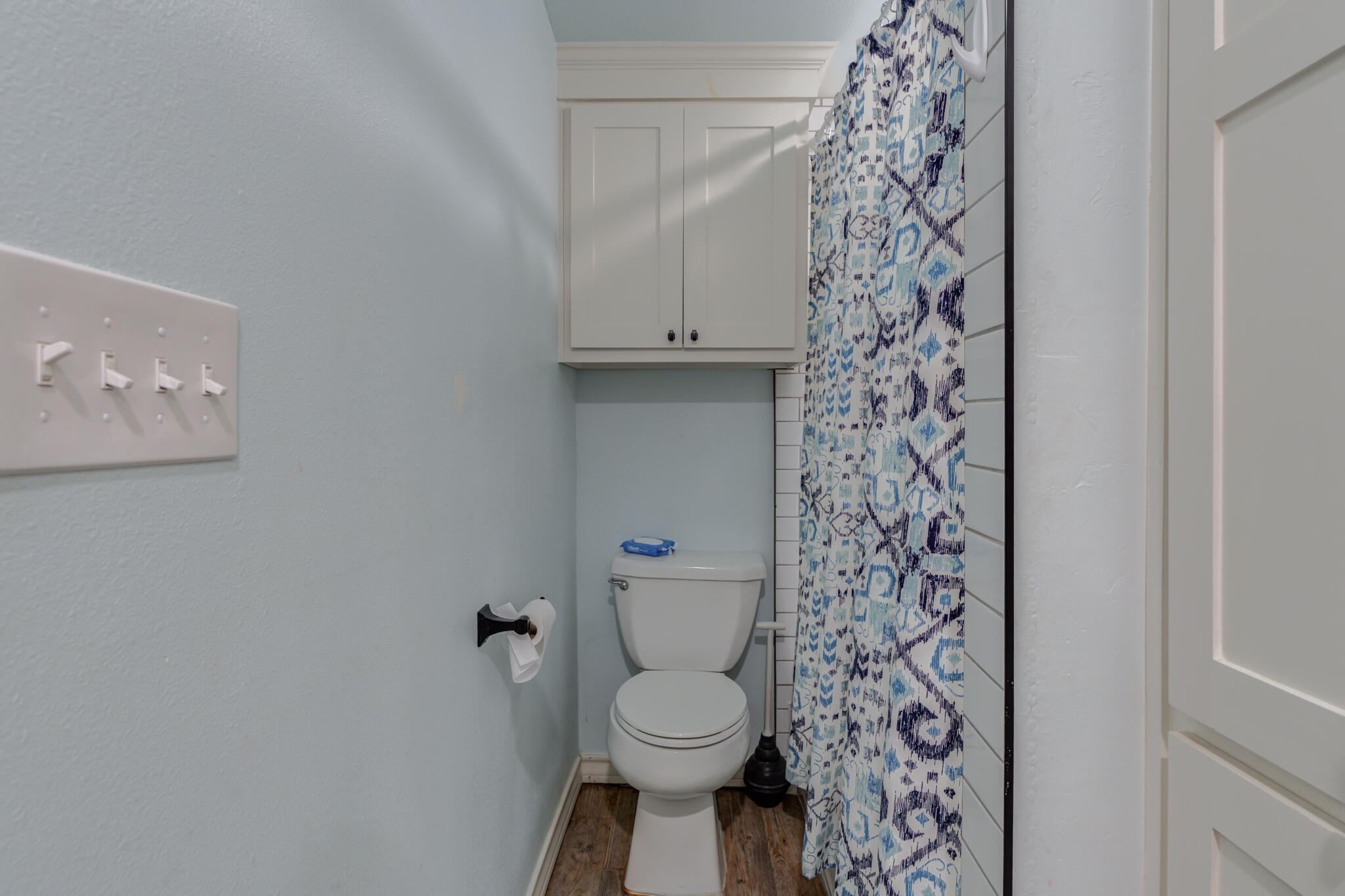 2741 County Road 3 Slaton, TX 79364 - Photo 39 of 51 a white toilet sitting next to a shower curtain