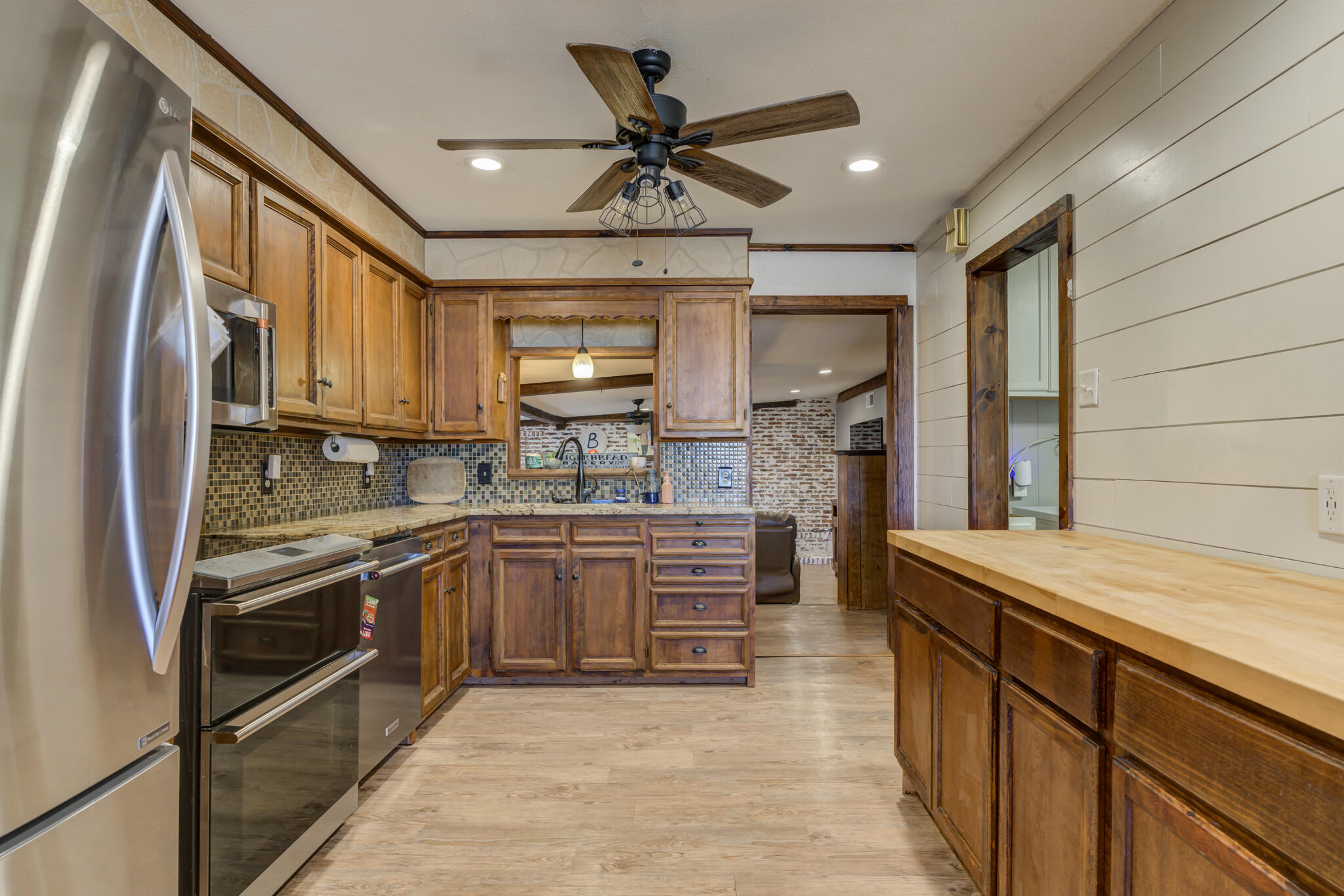 2741 County Road 3 Slaton, TX 79364 - Photo 7 of 51 a kitchen with stainless steel appliances granite countertop a sink stove and refrigerator