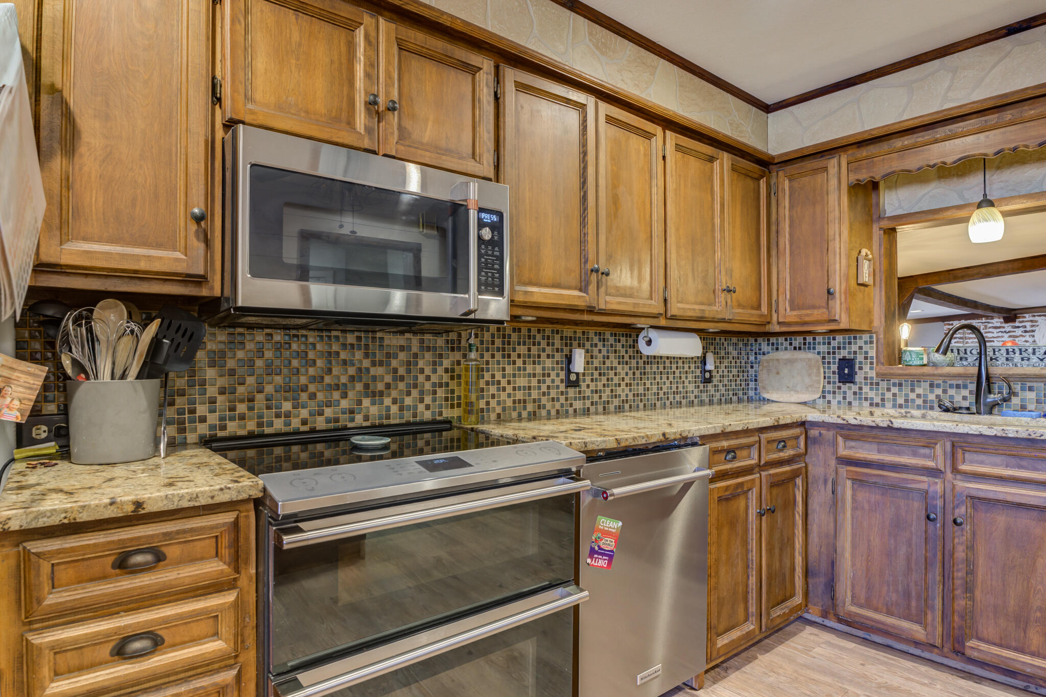 2741 County Road 3 Slaton, TX 79364 - Photo 9 of 51 a kitchen with stainless steel appliances granite countertop a stove microwave and cabinets