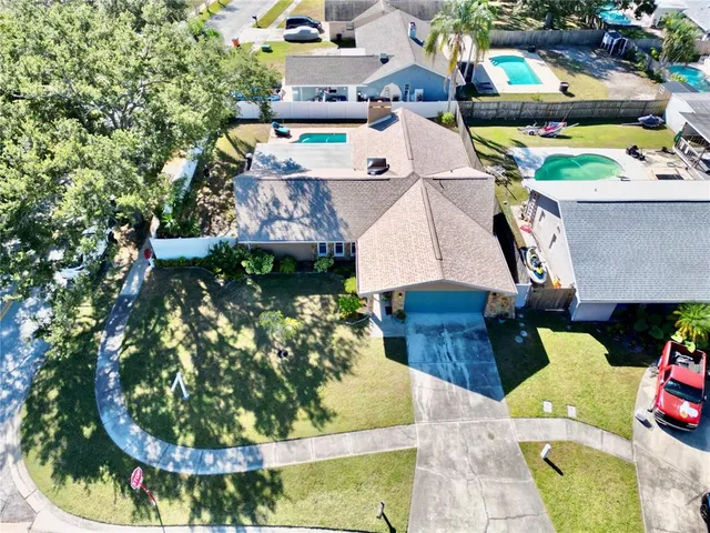 a view of a house with a yard and potted plants
