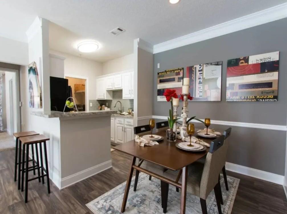 100 Crossing Boulevard, Unit 1518 McDonough, GA 30253 - Photo 2 of 26 a kitchen with a dining table chairs and refrigerator