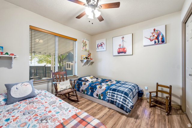 5196 Rodeo Circle Oakley, UT 84055 - Photo 21 of 57 Bright room featuring wood-finish flooring and a ceiling fan with integrated lighting