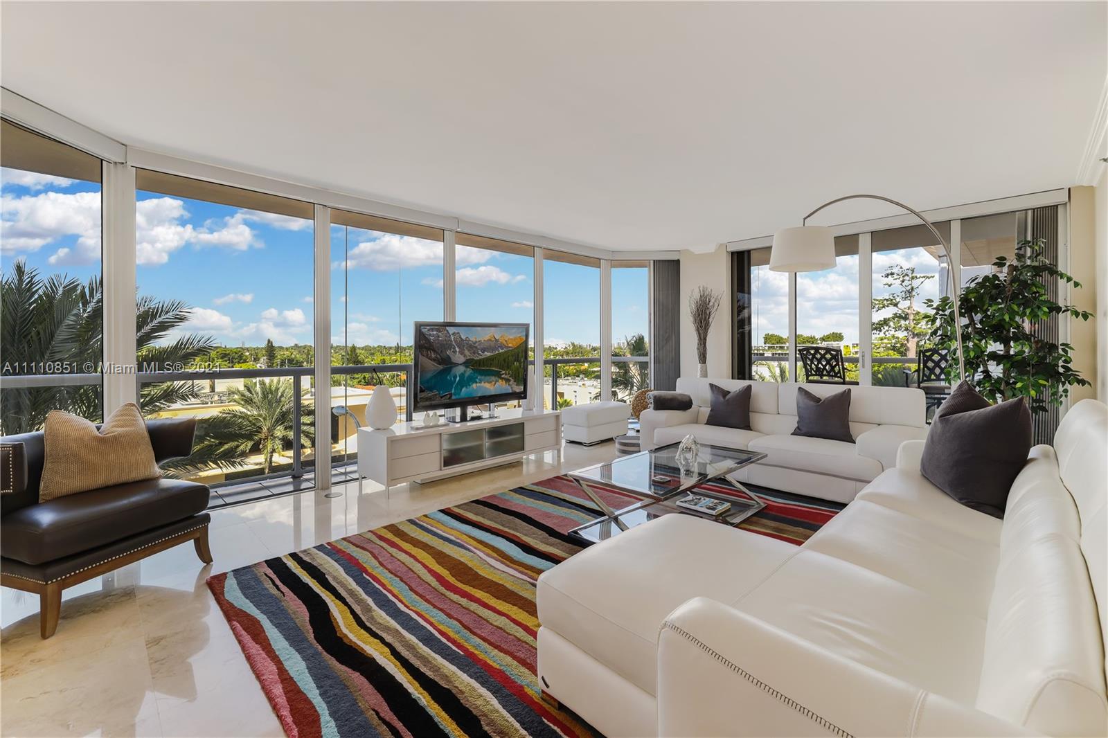 a living room with furniture fireplace and a large window