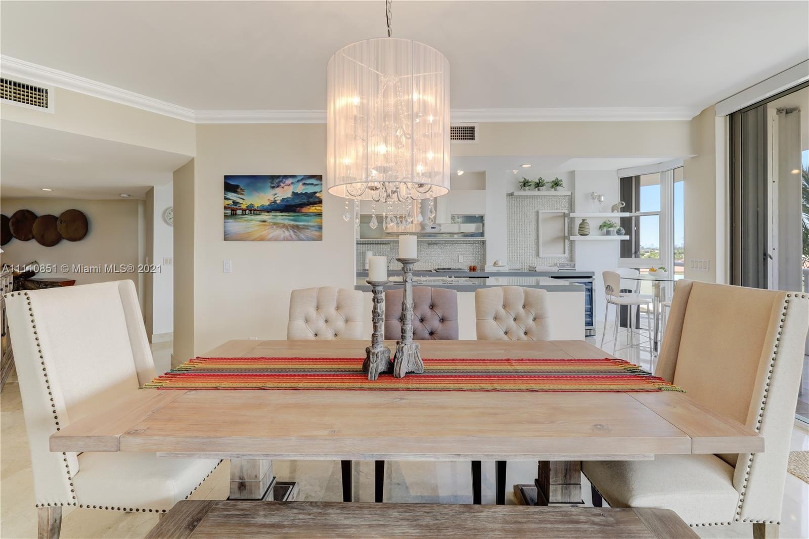 8925 Collins Avenue, Unit 5E Surfside, FL 33154 - Photo 15 of 54 a living room with furniture and a chandelier