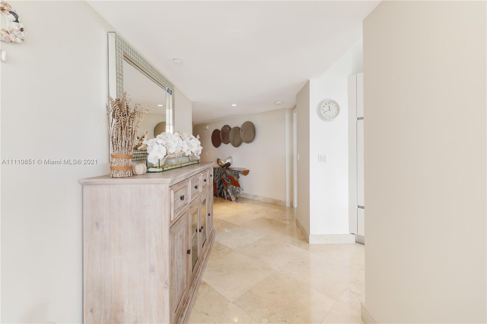 8925 Collins Avenue, Unit 5E Surfside, FL 33154 - Photo 16 of 54 a en suite bathroom with a granite countertop sink and a mirror