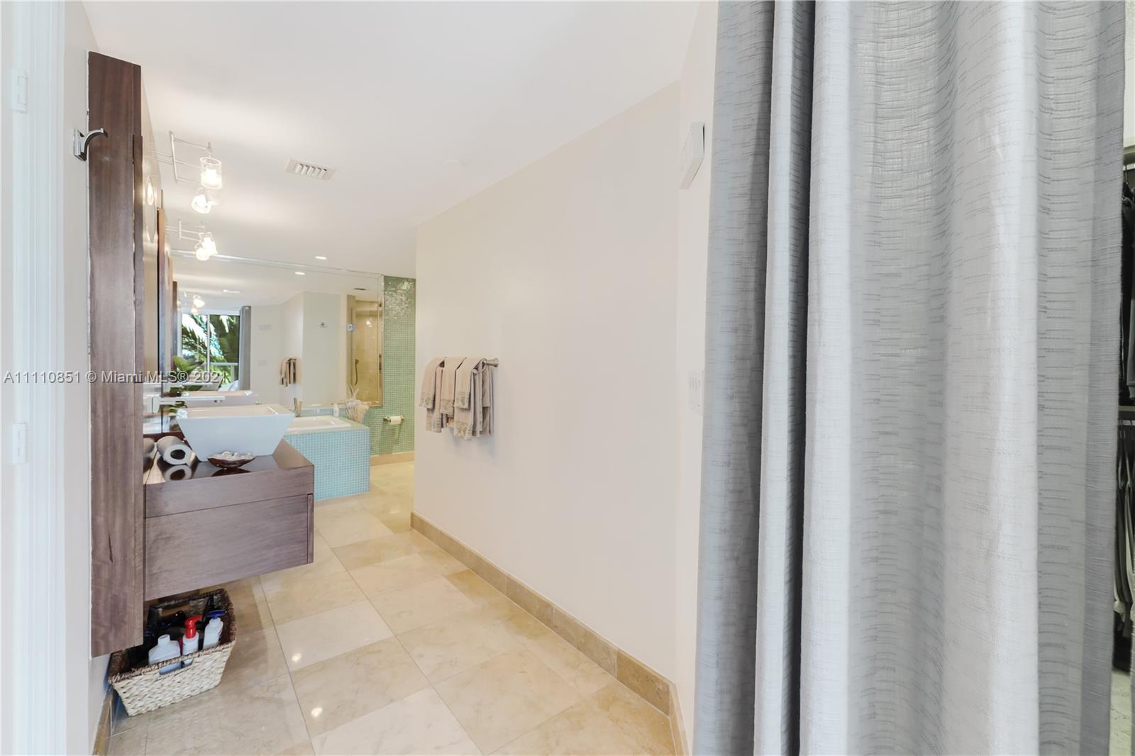 8925 Collins Avenue, Unit 5E Surfside, FL 33154 - Photo 25 of 54 a view of a hallway with couch and a dining room view