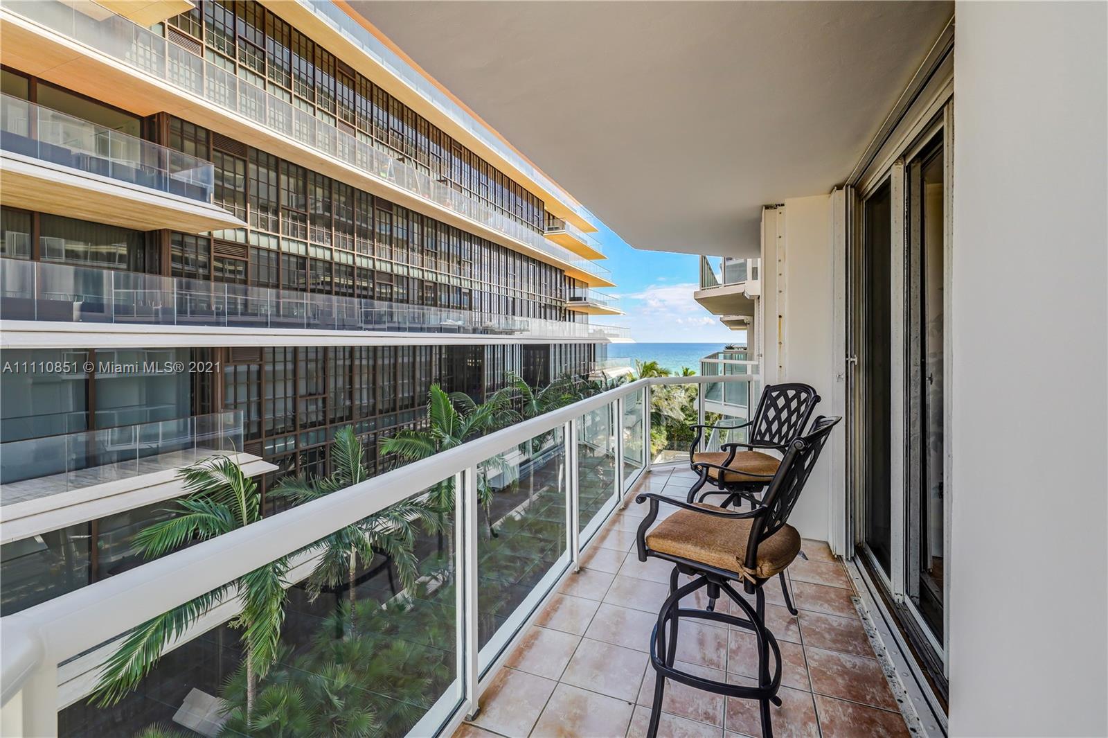 8925 Collins Avenue, Unit 5E Surfside, FL 33154 - Photo 39 of 54 a balcony with wooden floor outdoor seating and city view