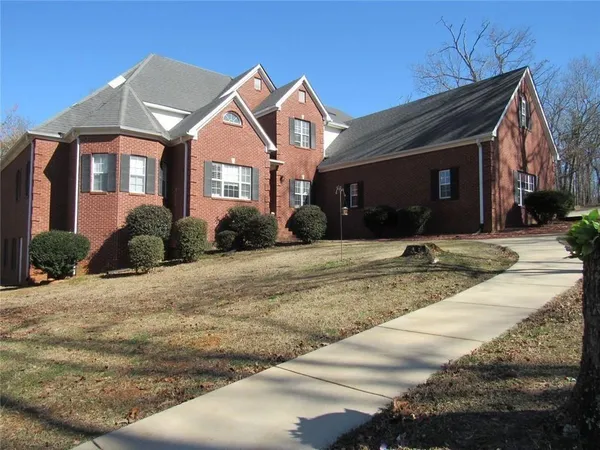 a front view of a house with a yard