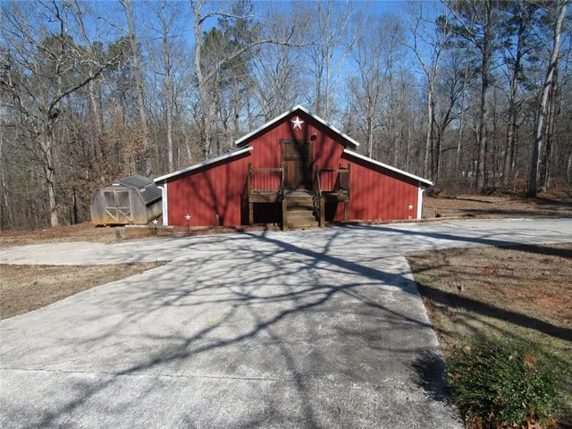 a kitchen with stainless steel appliances granite countertop a sink a stove and a wooden floors