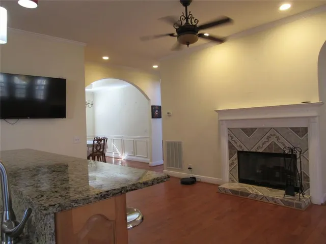 a living room with furniture and a ceiling fan