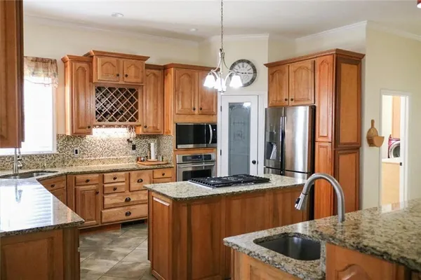 a view of a small space with wooden floor and a chandelier fan