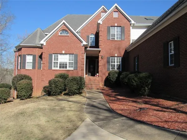 a view of a backyard with a large tree