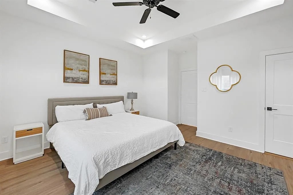 6814 Burkett Street, Unit B Houston, TX 77021 - Photo 13 of 22 a bedroom with a bed and chandelier