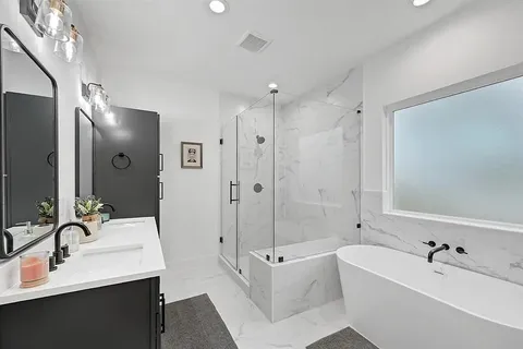 a bathroom with a tub sink double and mirror