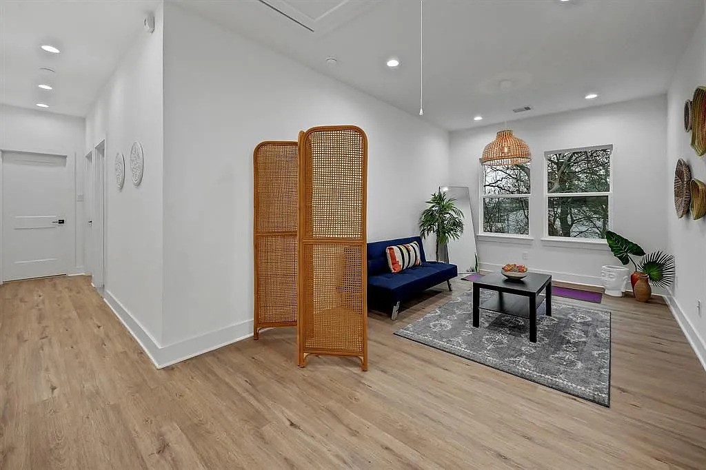 6814 Burkett Street, Unit B Houston, TX 77021 - Photo 15 of 22 a living room with furniture a table and wooden floor