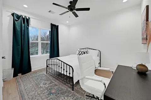 a bedroom with furniture and a window