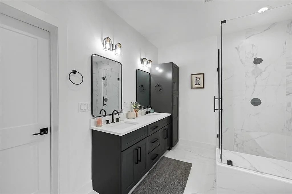 6814 Burkett Street, Unit B Houston, TX 77021 - Photo 18 of 22 a bathroom with a double vanity sink mirror and shower
