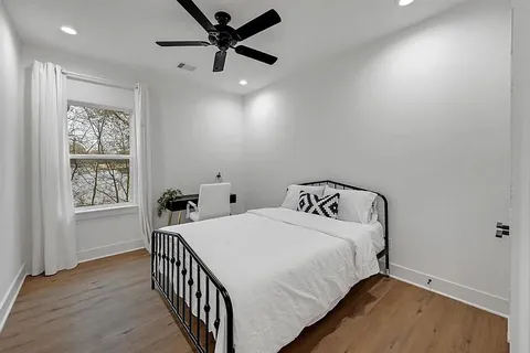 a bedroom with a bed and a window