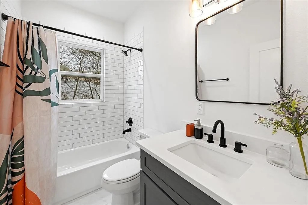 6814 Burkett Street, Unit B Houston, TX 77021 - Photo 21 of 22 a bathroom with a sink a toilet and shower curtain