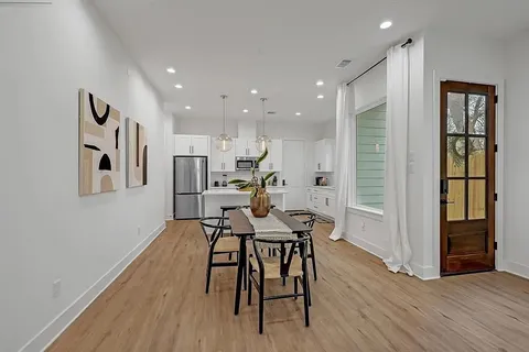 a view of a dining room with furniture and wooden floor