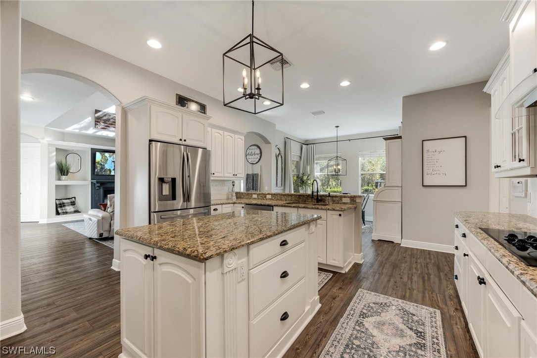 17280 Frank Road Alva, FL 33920 - Photo 12 of 49 a kitchen with stainless steel appliances granite countertop a sink stove and refrigerator