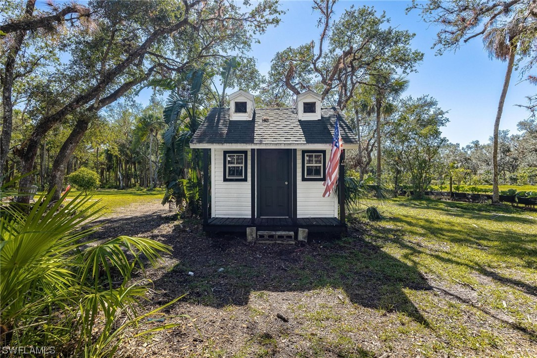 17280 Frank Road Alva, FL 33920 - Photo 42 of 49 a front view of a house with a yard