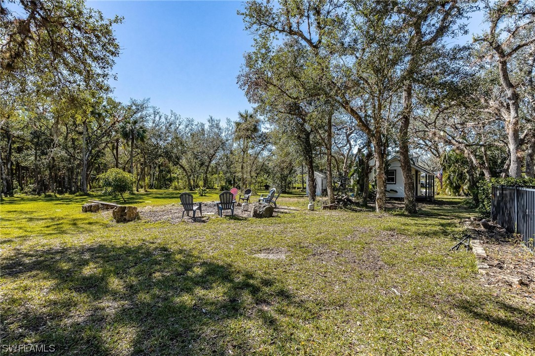 17280 Frank Road Alva, FL 33920 - Photo 44 of 49 a view of yard with swimming pool and trees