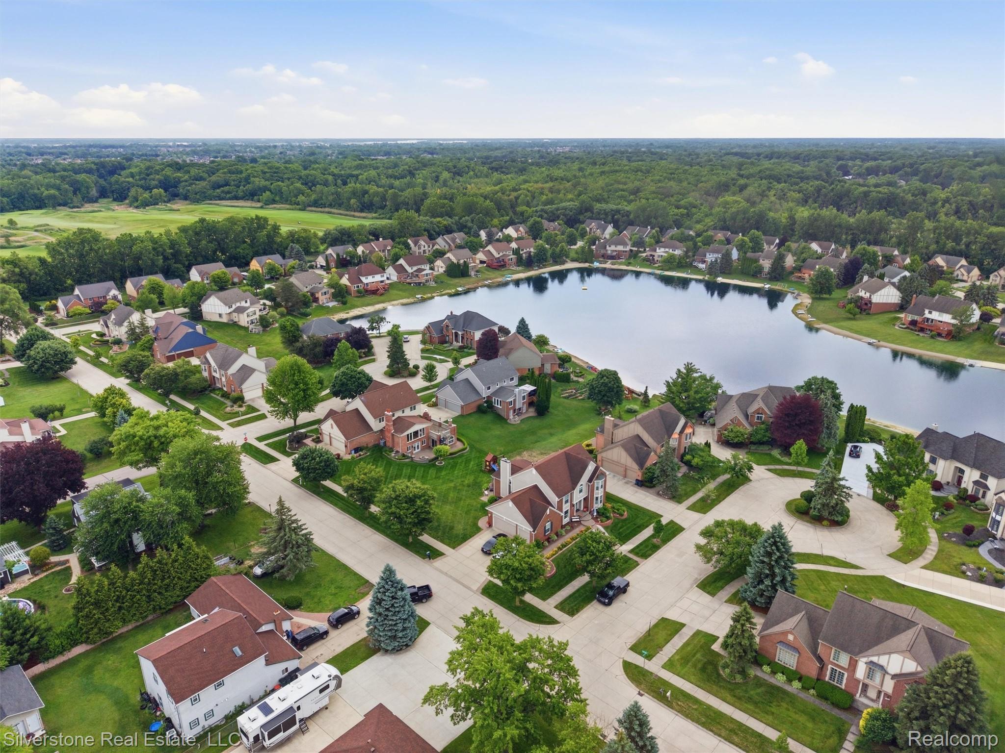 6577 Edith Court Troy, MI 48085 - Photo 58 of 61 Aerial perspective showcasing a residential community with a central lake