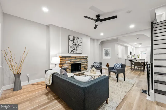 a living room with furniture and a fireplace