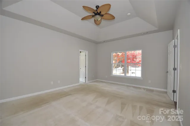 a view of empty room with ceiling fan