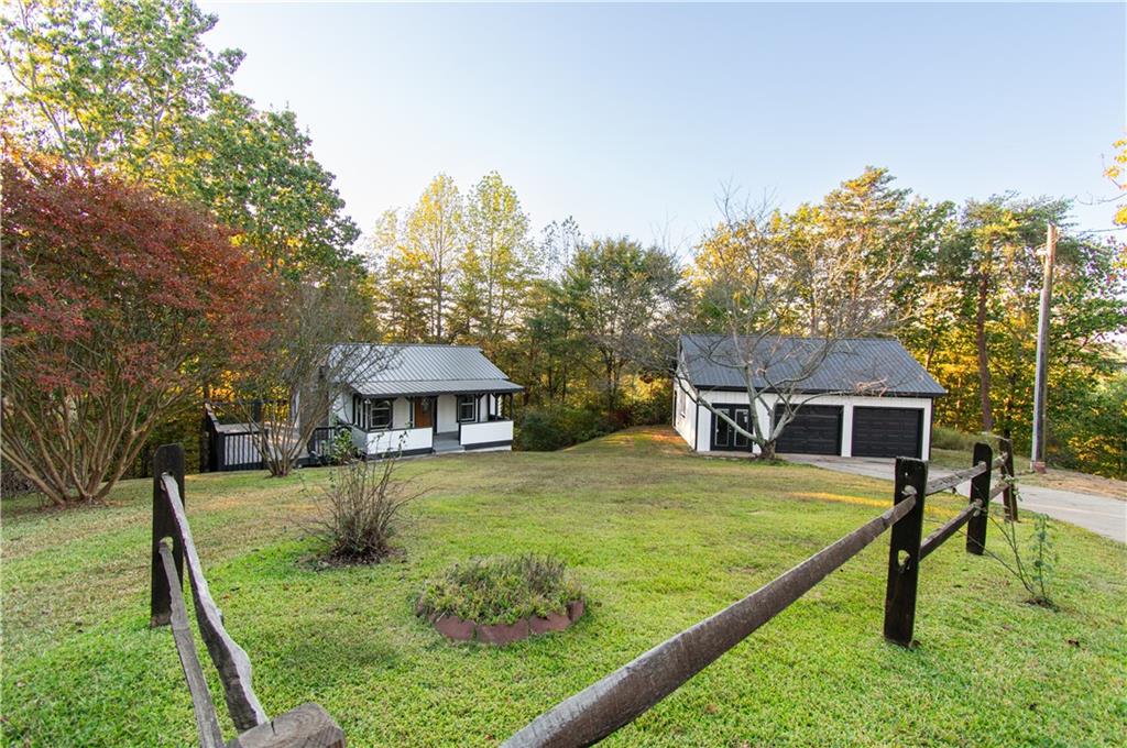 a view of a house with yard and trees