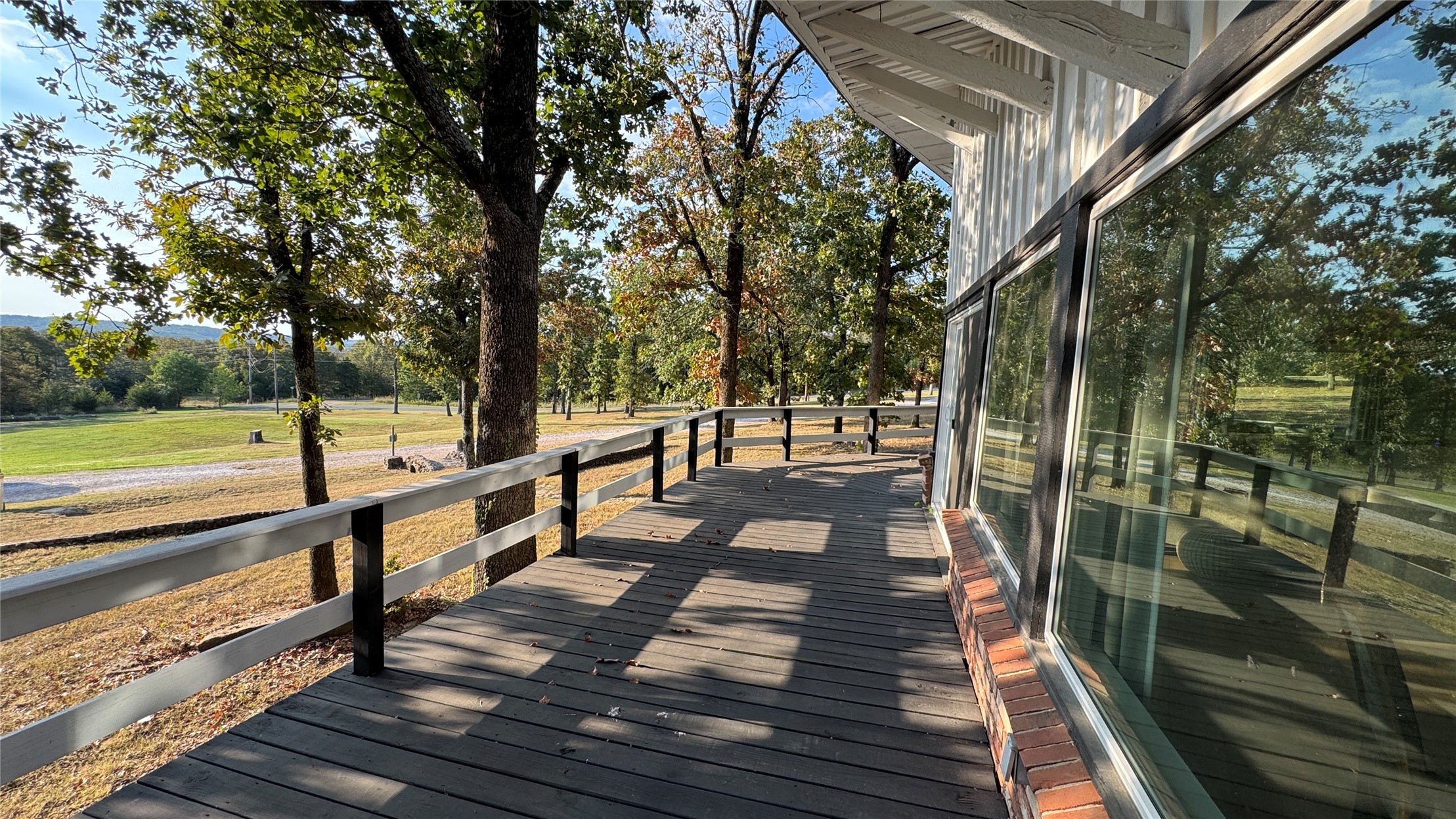 96358 South 4531 Road Vian, OK 74962 - Photo 40 of 58 Exterior wood deck with railings, large windows, and brick detailing