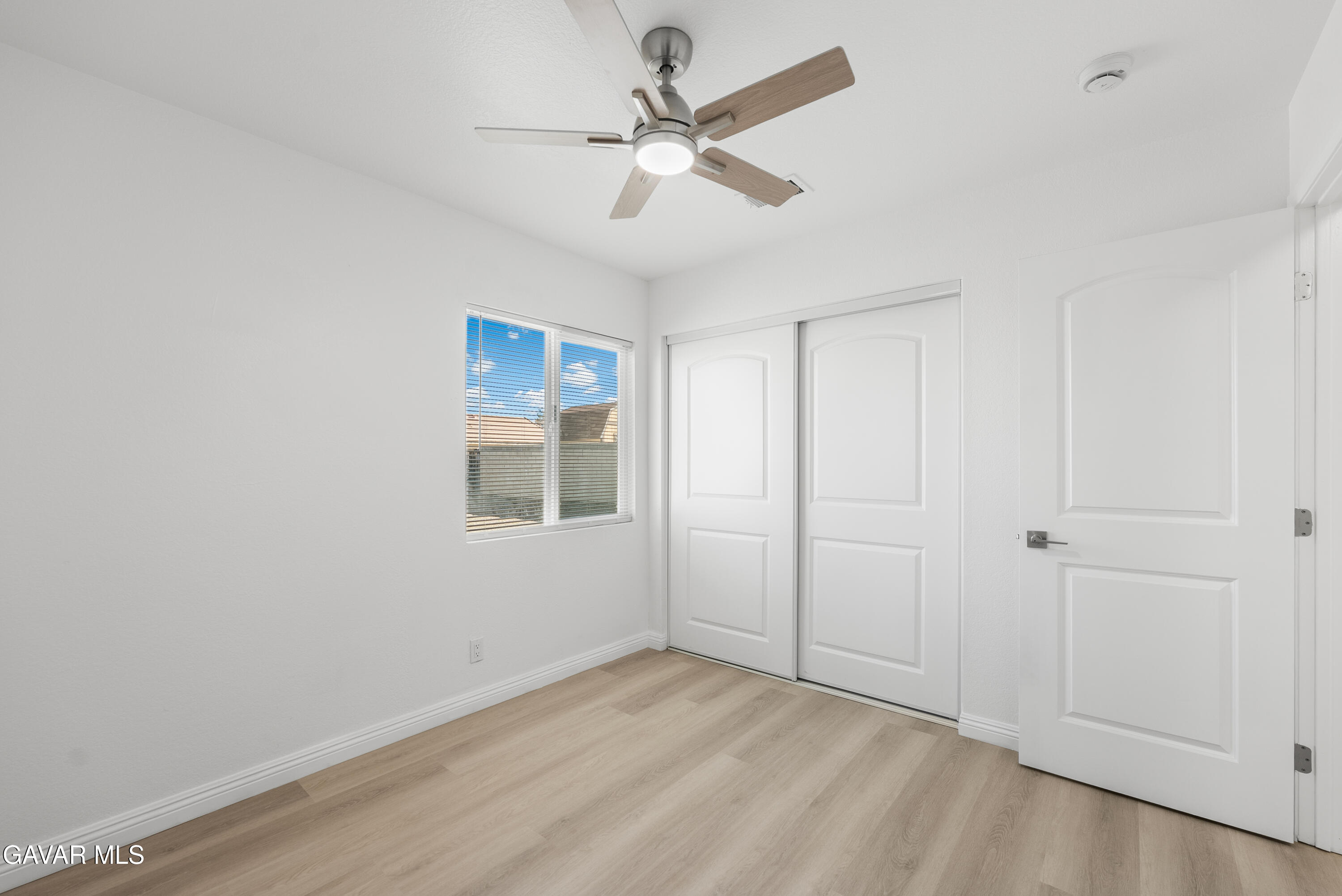 44238 Encanto Way Lancaster, CA 93536 - Photo 15 of 32 an empty room with fan and windows
