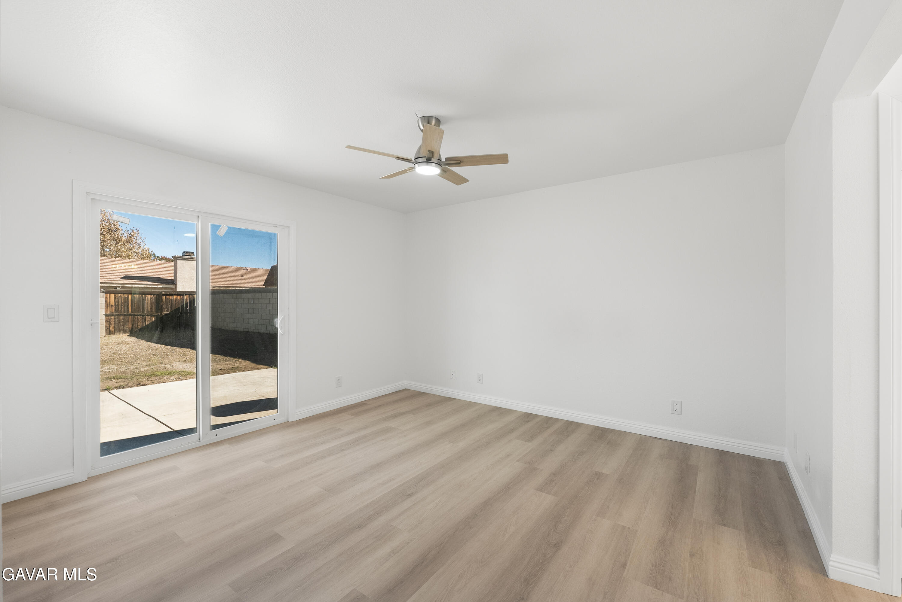 44238 Encanto Way Lancaster, CA 93536 - Photo 16 of 32 an empty room with wooden floor and ceiling fan