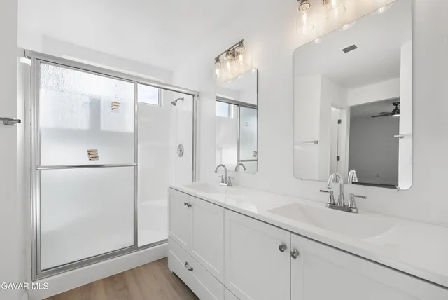 a bathroom with a double vanity sink mirror and double
