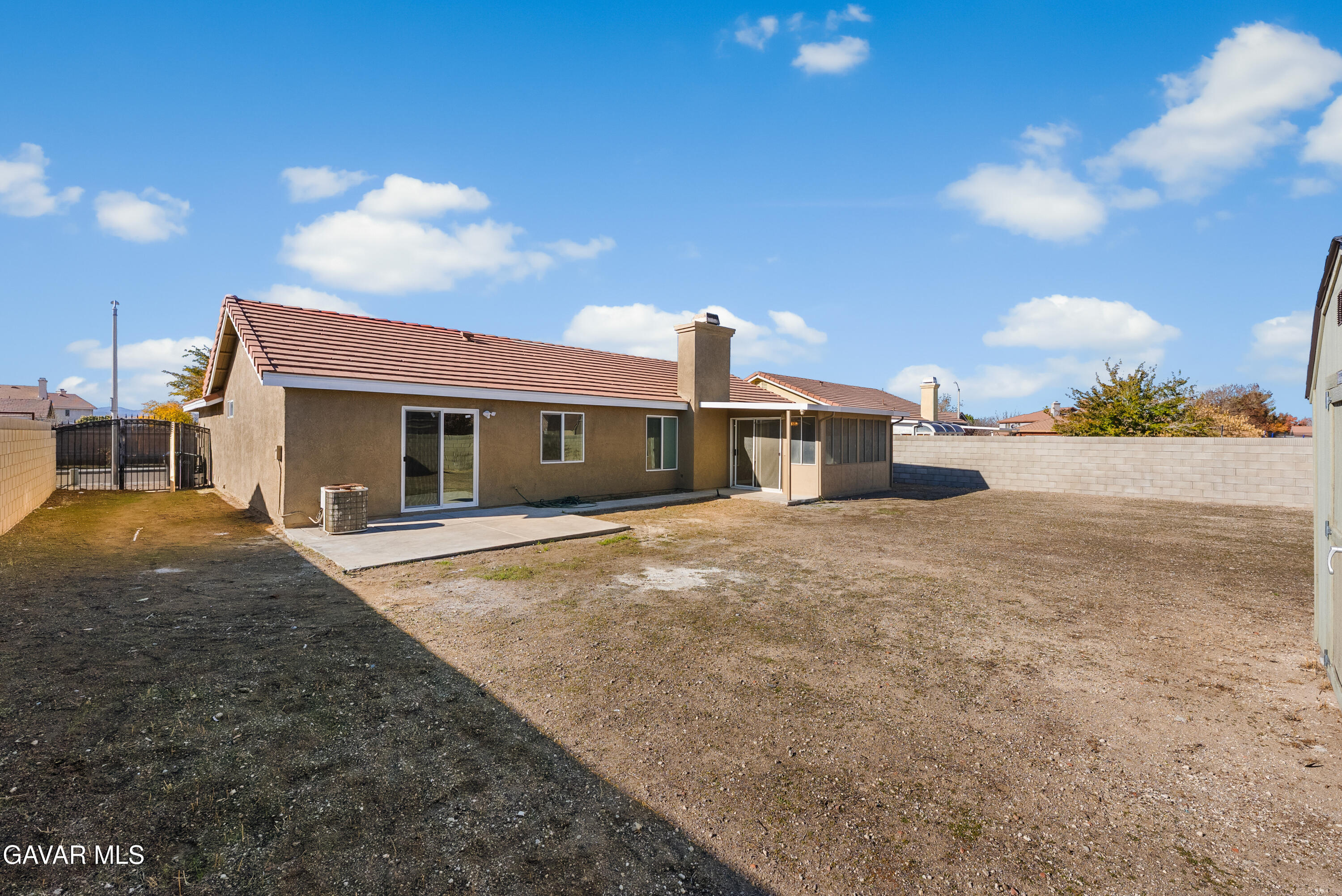 44238 Encanto Way Lancaster, CA 93536 - Photo 26 of 32 a front view of a house with a yard and garage