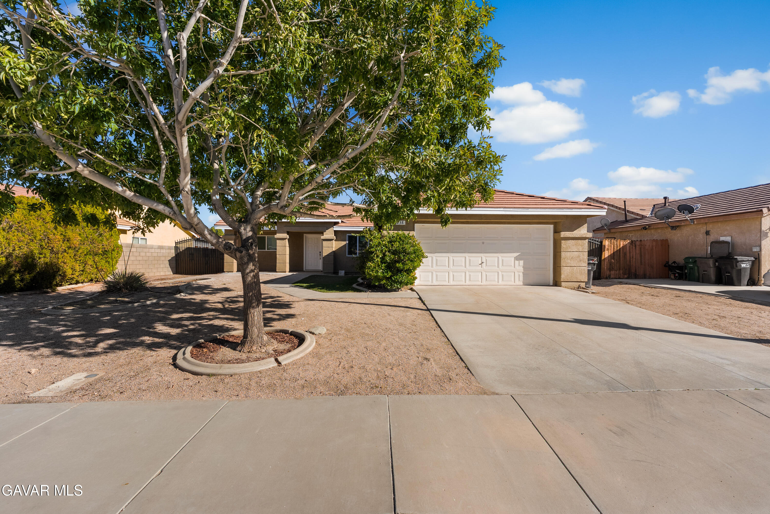 44238 Encanto Way Lancaster, CA 93536 - Photo 30 of 32 a view of a white house with a large tree
