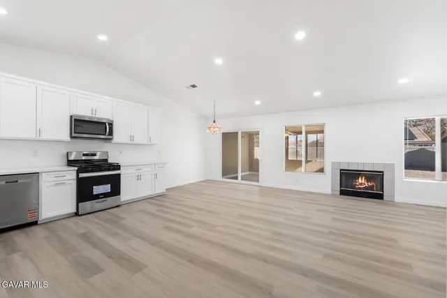 a kitchen with granite countertop a stove top oven and sink