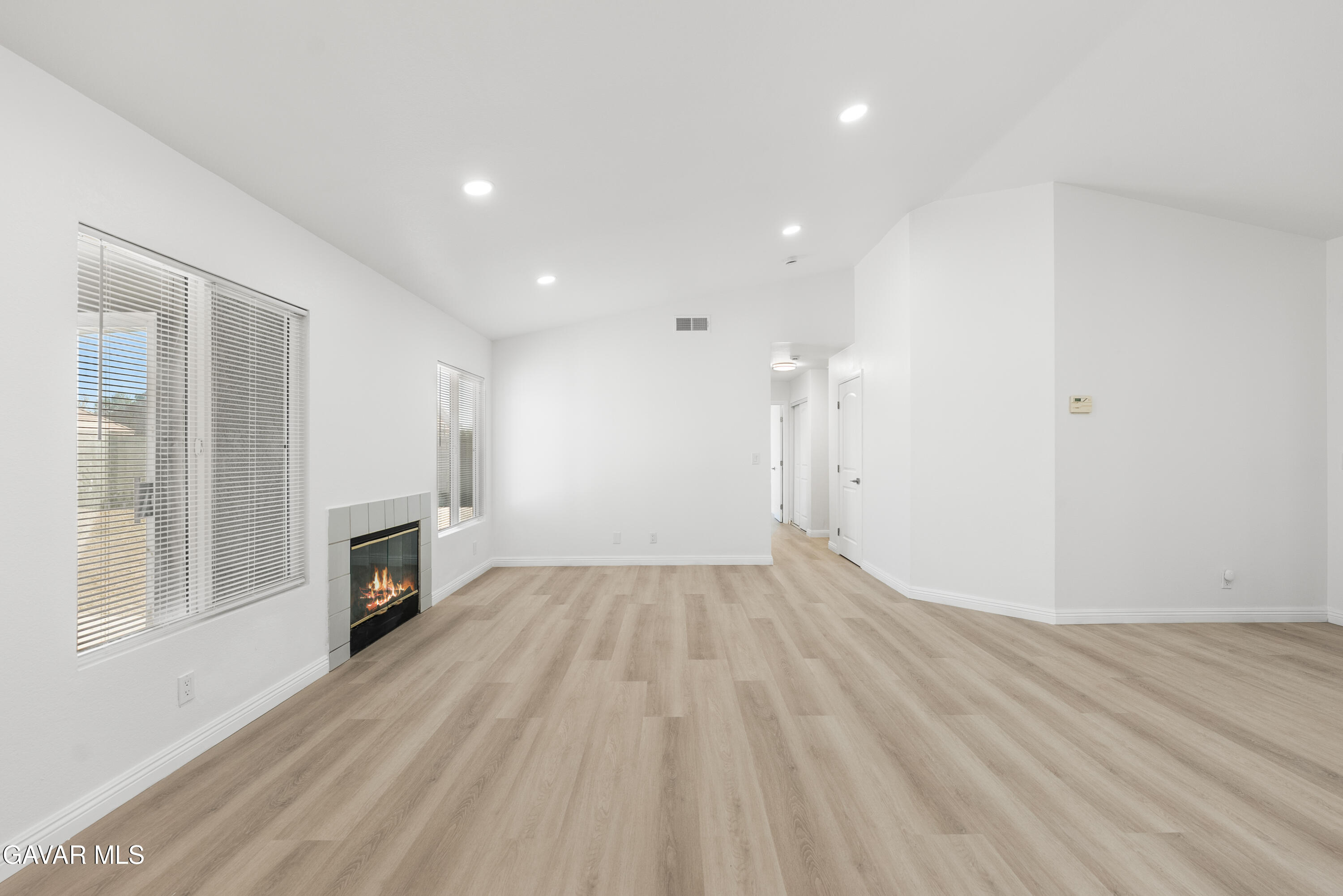 44238 Encanto Way Lancaster, CA 93536 - Photo 7 of 32 a view of empty room with wooden floor and fireplace