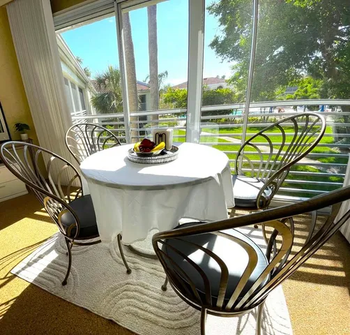 a view of a living room and dining room with furniture wooden floor and a chandelier